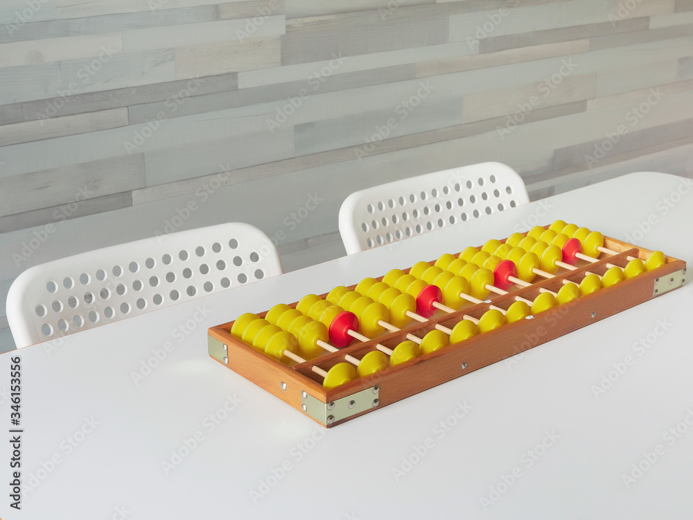 Naklejka premium Classes in mental arithmetic, abacus soroban on a white table. closeup. copy space.