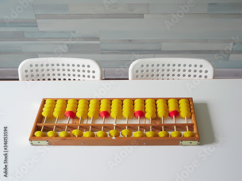 Classes in mental arithmetic  abacus soroban on a white table. closeup. copy space.