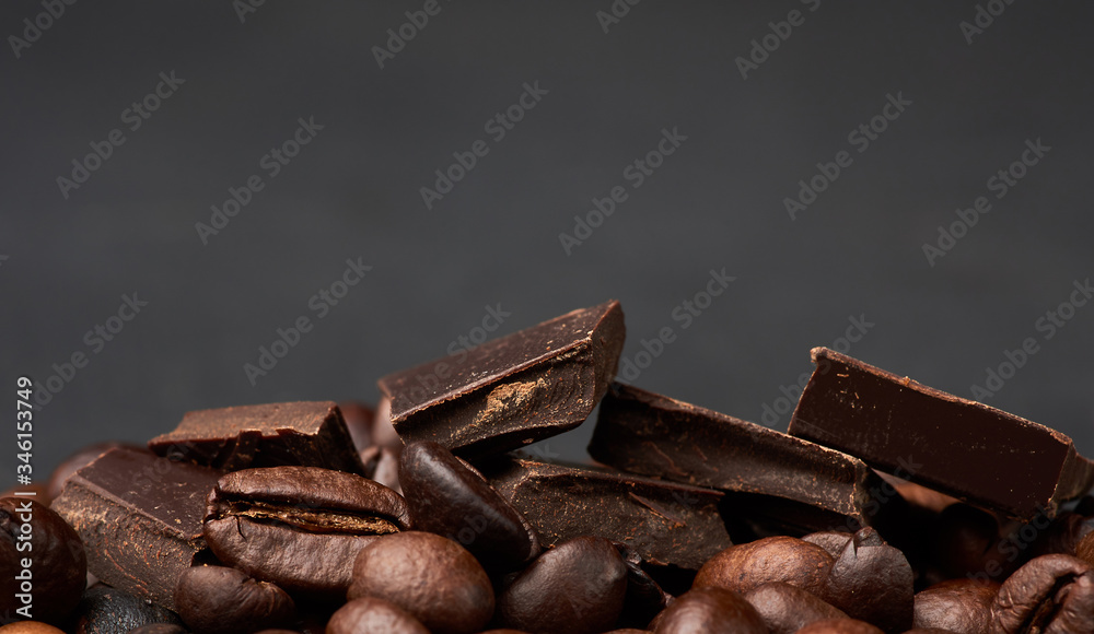 pieces of dark chocolate and roasted brown grains of Robusta coffee pieces of dark chocolate and roasted brown grains of Robusta coffee