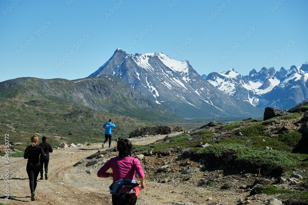 People jogging in the beautiful Tasermiut fjord in Greenland