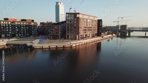 4K Helsinki Baltic Sea Finnish Bay lagoon early summer morning aerial video, Kalasatama upmarket neighborhood near Mustikkamaa Island over calm water channel in Finland capital Suomi northern Europe photo