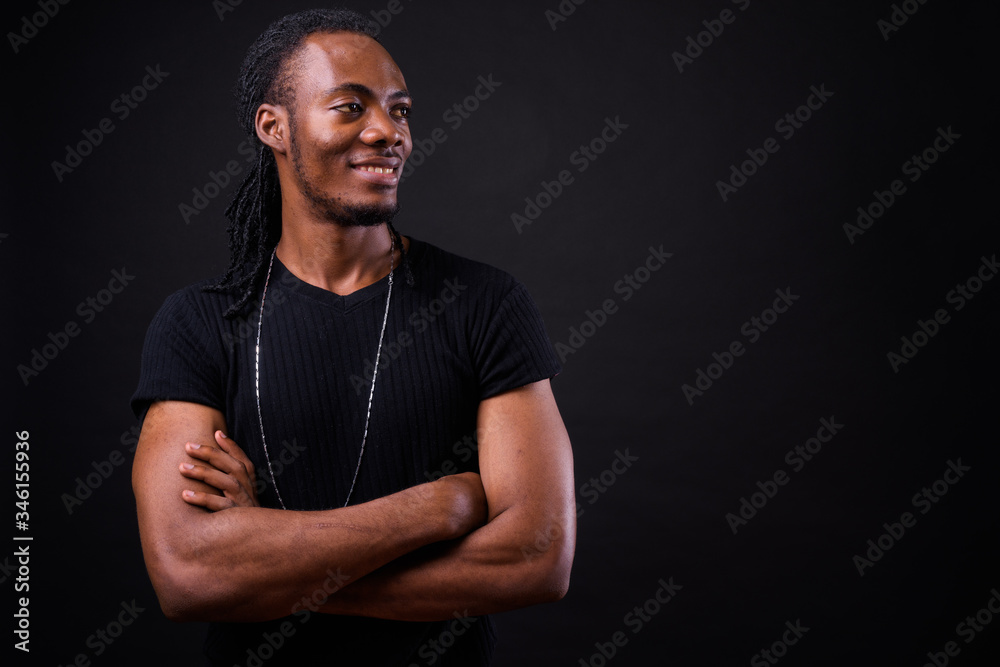 Portrait of young handsome African man with dreadlocks