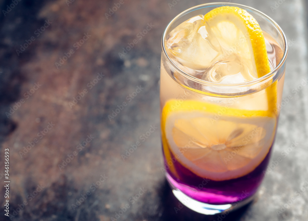 Gin based colorful cocktail with lemon and lavender liqueur on the rustic background. Selective focus. Shallow depth of field. Gin based colorful cocktail with lemon and lavender liqueur on the rustic background. Selective focus. Shallow depth of field.