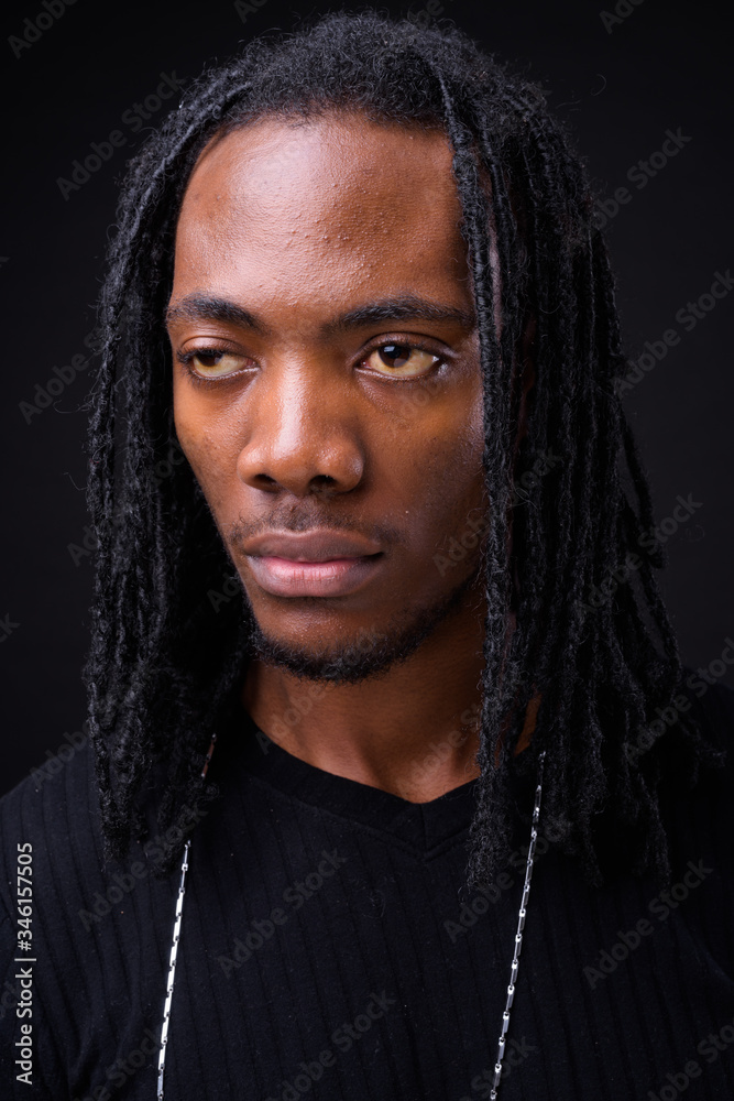 Face of young handsome African man with dreadlocks Face of young handsome African man with dreadlocks