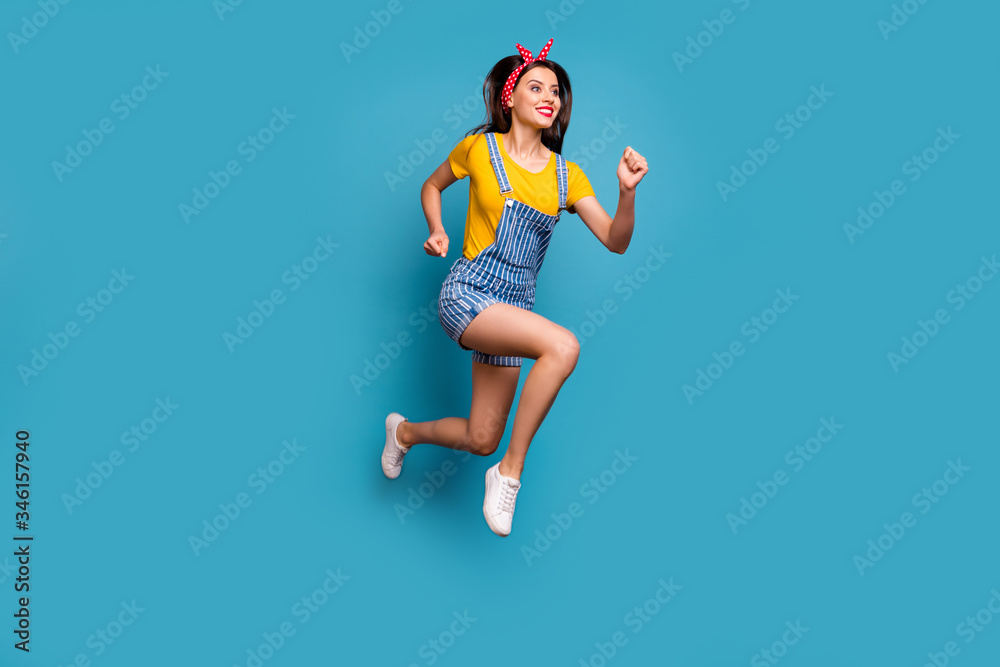 Fototapeta premium Full length body size view of her she nice attractive lovely cheerful cheery girl jumping running fast healthy life isolated on bright vivid shine vibrant blue teal turquoise color background