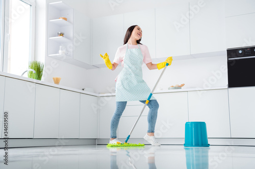 Full length body size view of her she nice attractive cheerful cheery girl washer wiping ceramic floor having fun dancing enjoying day in modern white light interior style kitchen