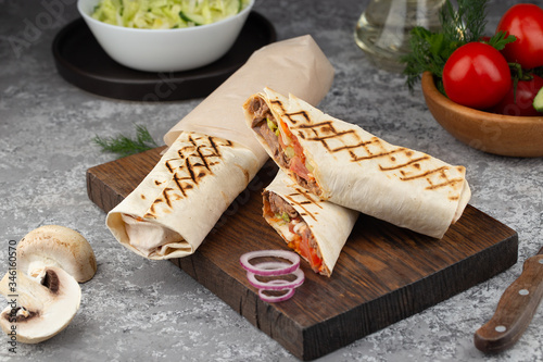 Meat and vegetables with sauce wrapped in lavash