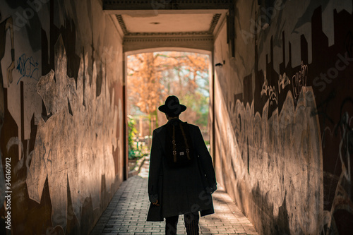 Boy with hat walking in alley