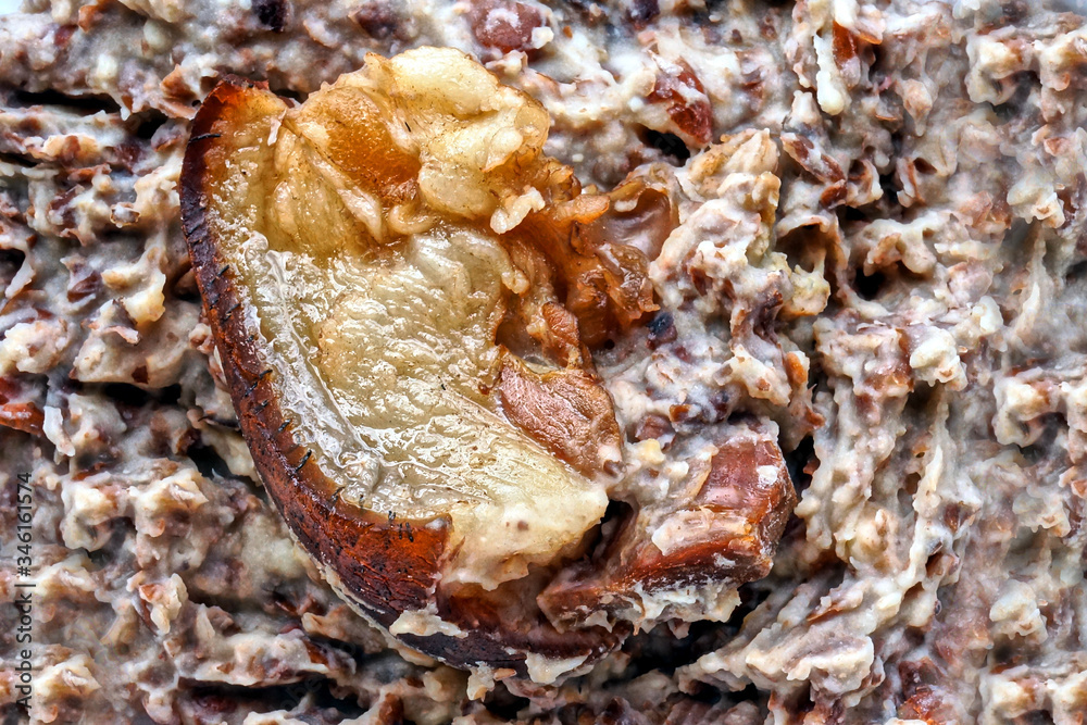 Closeup of smoked pork on mashed pinto beans Closeup of smoked pork on mashed pinto beans