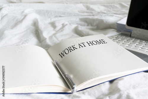 Work at home text on book with laptop