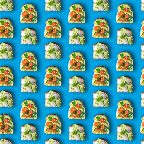 Seamless pattern sandwich with tomato or or radish with cucumber, with avocado and cottage cheese sauce, sprinkled with grees. Healthy food flatlay in pop art style on a blue background.