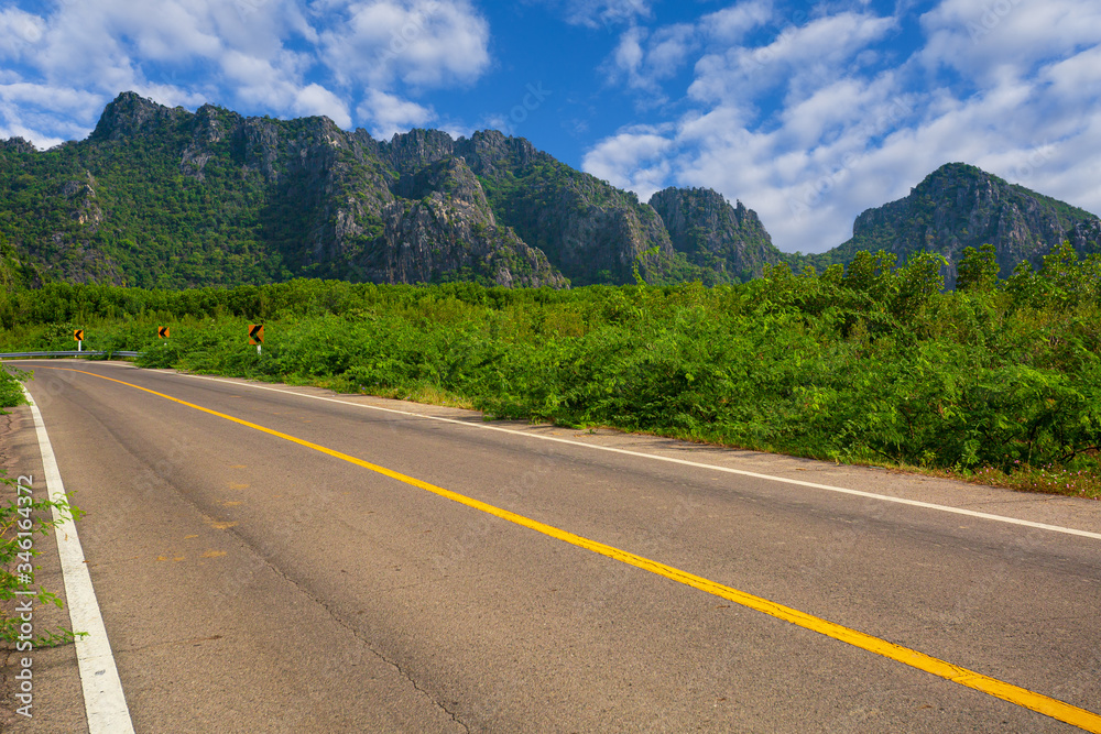 Fototapeta premium Green mountain and empty asphalt highway natural scenery ,Asphalt highways and mountains under the blue sky