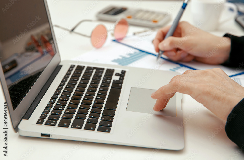 A young specialist works with financial documents A young specialist works with financial documents