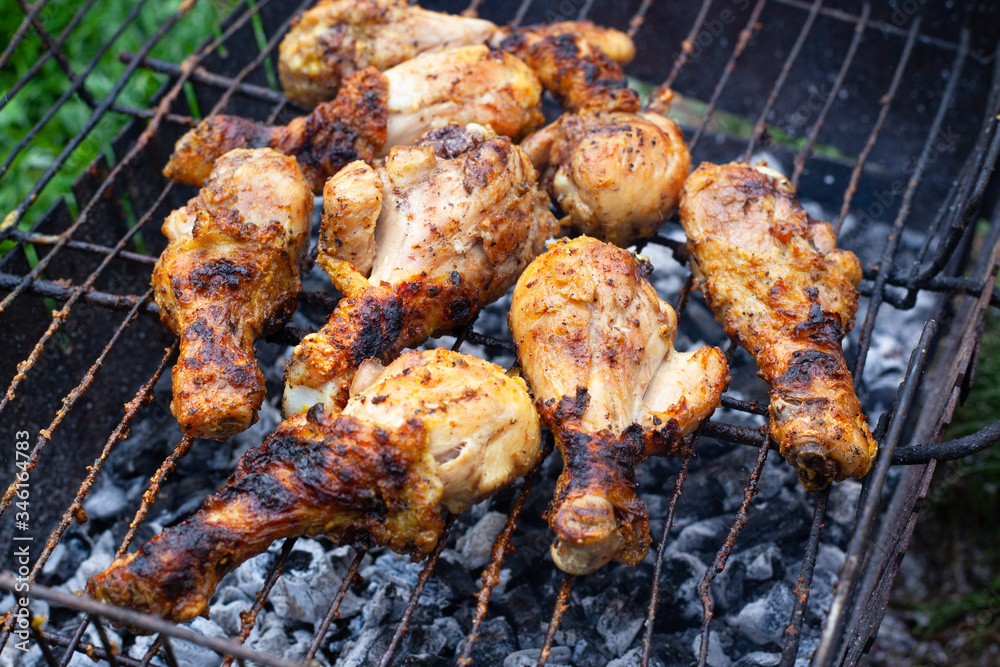toasted chicken drumstick with crispy crust on the grill. B-B-Q, picnic, delicious dinner cooked outdoors