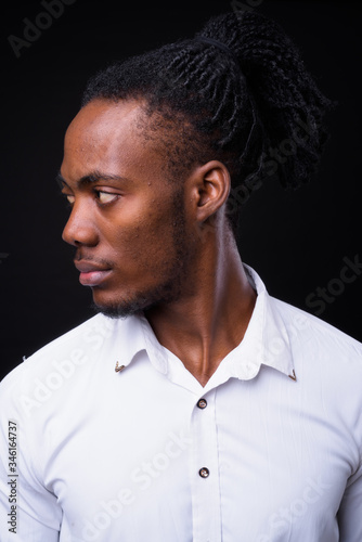 Face of young handsome African businessman with dreadlocks