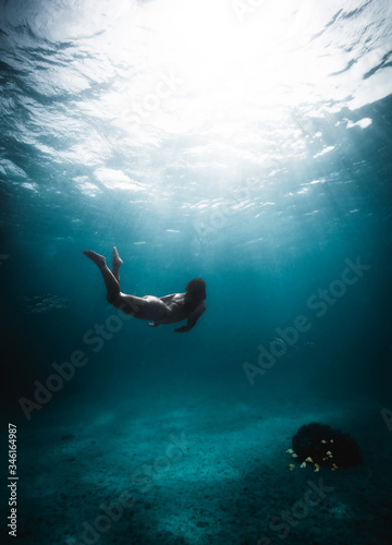 Girl diving in the middle of the Caribbean Sea © alessiosaveri
