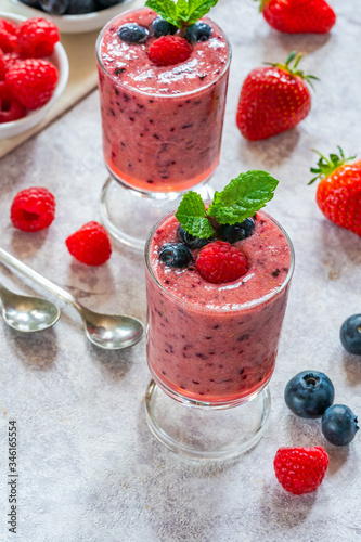 Mixed berry smoothie garnished with fresh fruit and mint