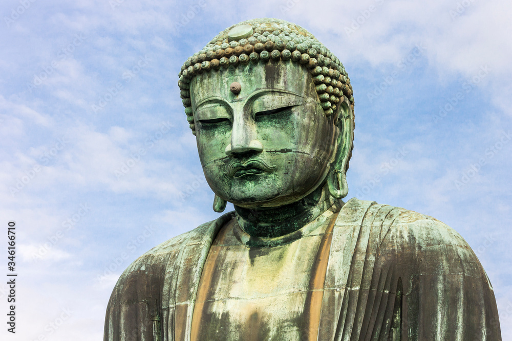 Kamakura, Japan. Views of the Great Buddha (Daibutsu), large bronze statue representing Amida Buddha (Amitabha) in Kotoku-in Buddhist temple Kamakura, Japan. Views of the Great Buddha (Daibutsu), large bronze statue representing Amida Buddha (Amitabha) in Kotoku-in Buddhist temple