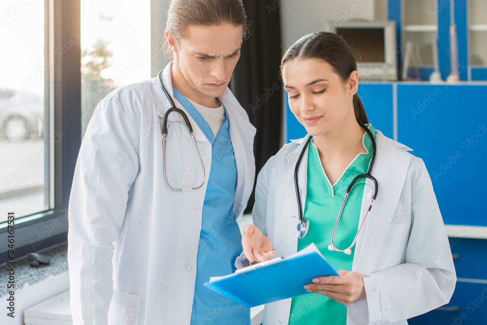 High angle nurses looking at clipboard High angle nurses looking at clipboard