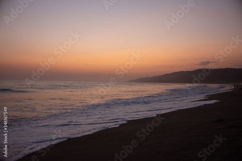 Fototapeta Naklejka Na Ścianę i Meble -  Sunset over the Ocean and the Beach