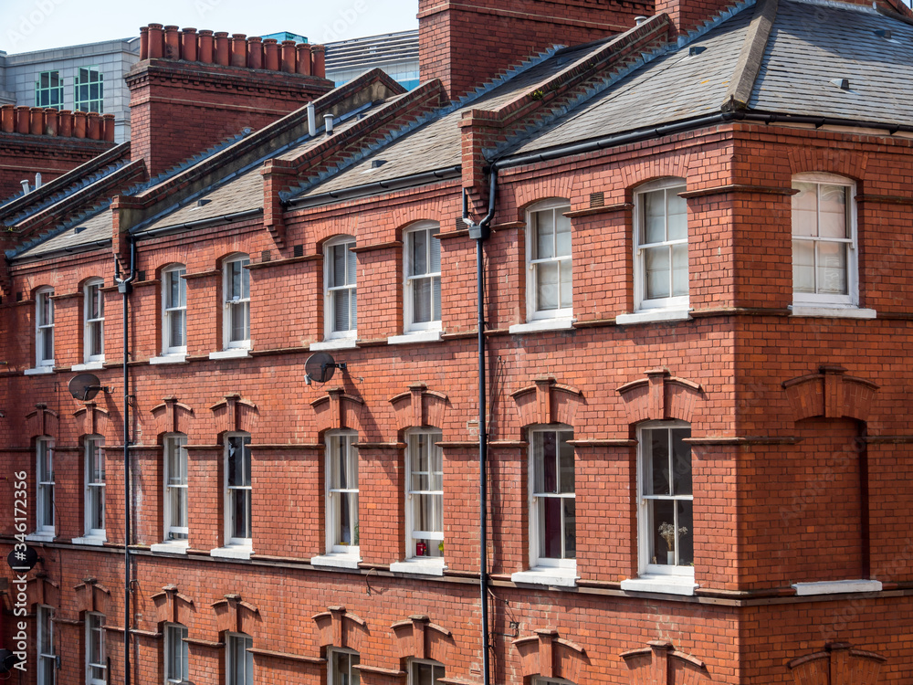 Obraz premium East London, England UK. Traditional red brick housing and flats. Sash windows and slate roof. Concept, buying, renting, estate agent, urban housing and living in the city, London lockdown, stay home.