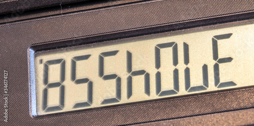 Old LCD calculator display upside down writing out a word asshole