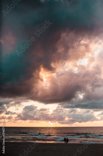 Sunset on the beach with huge clouds © Sem