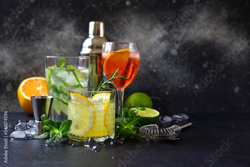 Fotobehang Three classic cocktails : aperol spritz, mojito and lemon cooler with rosemary with ingredients for making and cocktail set
