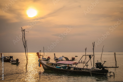Fishing boats on the sea coast in the evening while sunset in Thailand