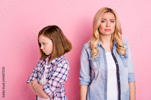 Frustrated disappointed mother daughter have misunderstanding kid girl cross hands feel offense mature woman cry wear denim jeans checkered plaid shirt isolated pastel color background