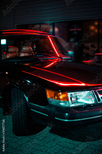 Fotografie Classic car stops at gas station at night