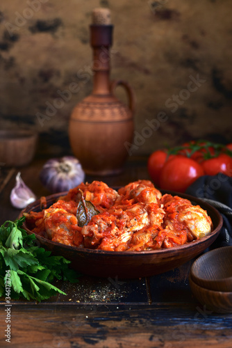 Chakhokhbili - traditional dish of georgian cuisine. Chicken stewed with vegetables : carrot, onion, tomatoes. photo