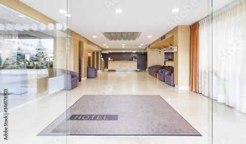 Photography Open glass door at entrance of modern hotel