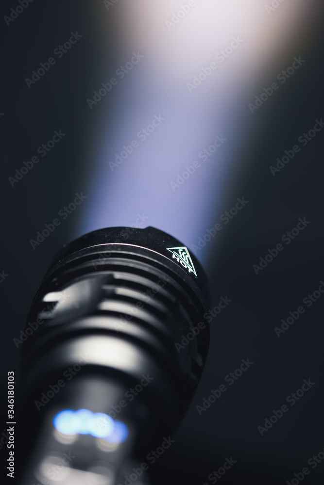 ray of pocket flashlight in smoke, copy-space background ray of pocket flashlight in smoke, copy-space background