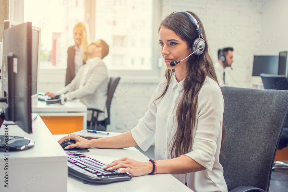 Portrait of attractive female support phone operator in headset at workplace Portrait of attractive female support phone operator in headset at workplace