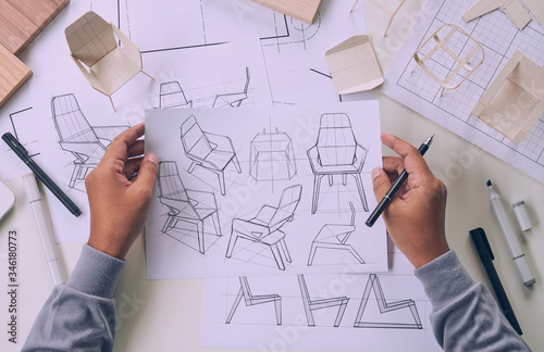 Designer sketching drawing design development product plan draft chair armchair Wingback Interior furniture prototype manufacturing production. designer studio concept . photo