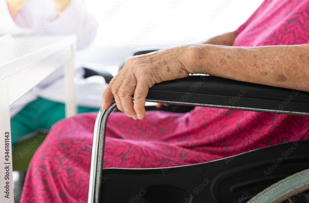 close up hand, old asian patient sitting on wheelchair, she talk about her symptoms with doctor in hospital, elderly healthcare promotion