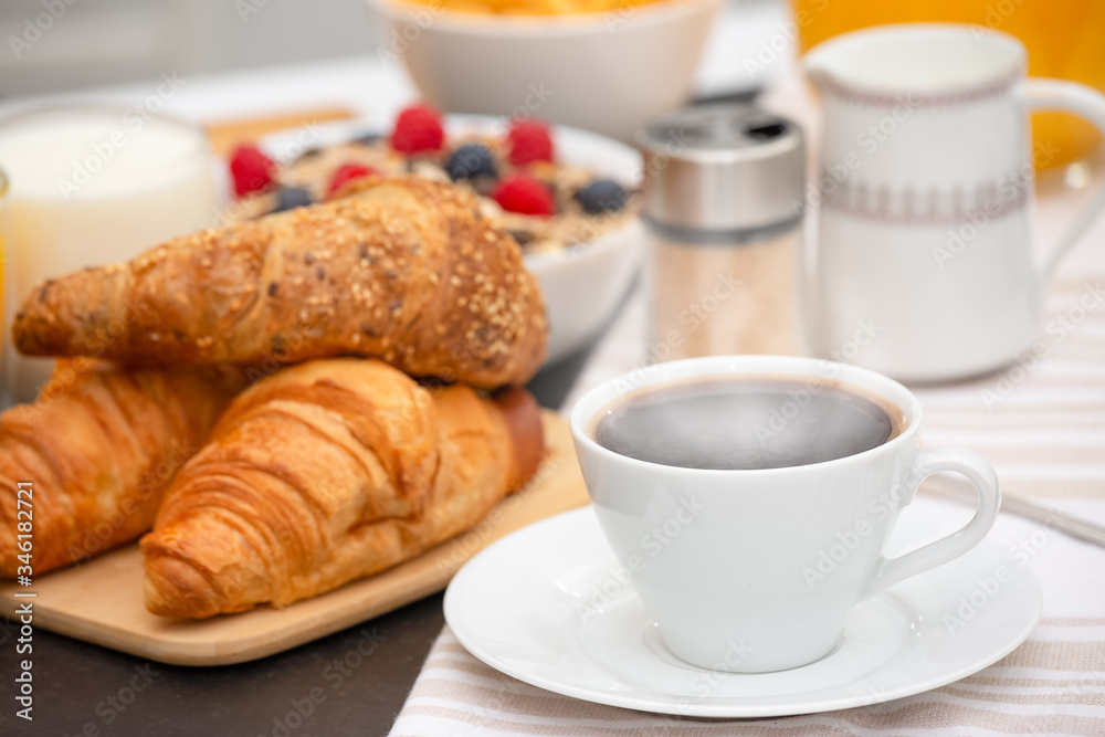 Breakfast Served in the morning with Hot black coffee and croissants Natural corn flake breakfast cereal in cups and fruit on the breakfast table every day