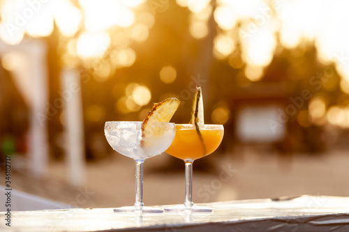 Tropical passion fruit juice alcoholic cocktail standing outdoor in sunlight 