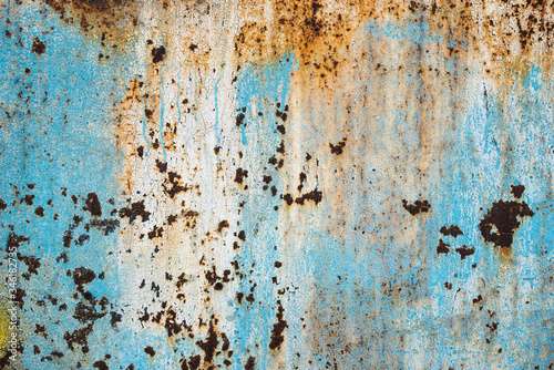 Texture of a rusty metal surface: dark blue, blue, aged cracked paint. Background of old painted sheet metal with rust painted in blue.