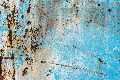 Texture of a rusty metal surface: dark blue, blue, aged cracked paint. Background of old painted sheet metal with rust painted in blue. © Maxim