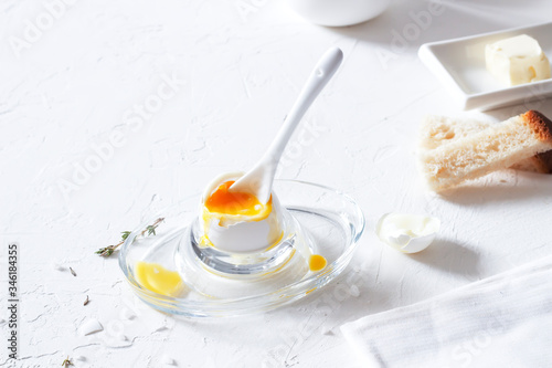 Traditional morning breakfast, boiled eggs, butter, bread, milk, on a white background, modern style