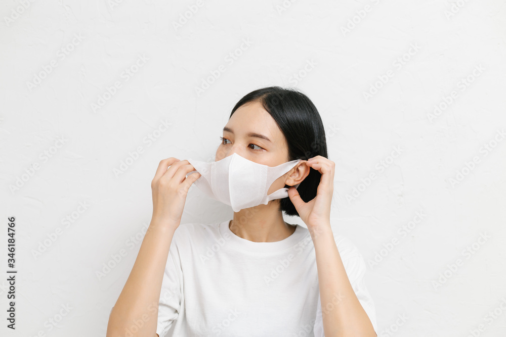 Young asian female wearing medical face mask to protect corona virus, studio portrait. Young asian female wearing medical face mask to protect corona virus, studio portrait.