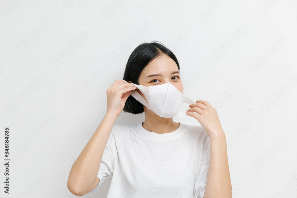 Young asian female wearing medical face mask to protect corona virus, studio portrait. Young asian female wearing medical face mask to protect corona virus, studio portrait.
