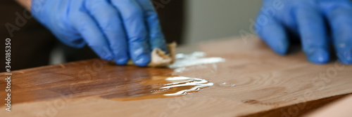 Schilderij op canvas Man varnishing table at workshop