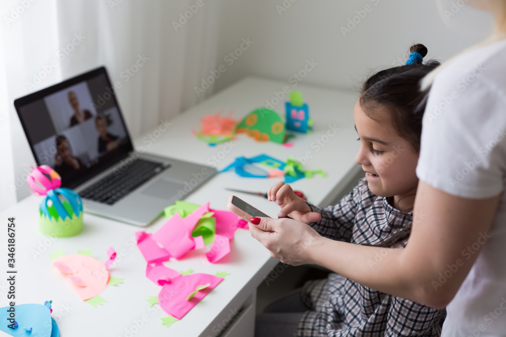 Working from home with kid. Happy daughter hugging mother. Young woman and cute child using laptop. Freelancer workplace. Female business, distance learning. Lifestyle family moment. Working from home with kid. Happy daughter hugging mother. Young woman and cute child using laptop. Freelancer workplace. Female business, distance learning. Lifestyle family moment.