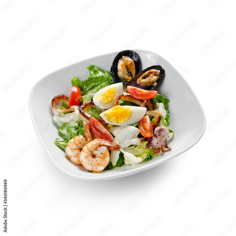 Seafood salad. Mussels, scallops, shrimp and squid with cherry, egg and sauce. Isolated on a white background.