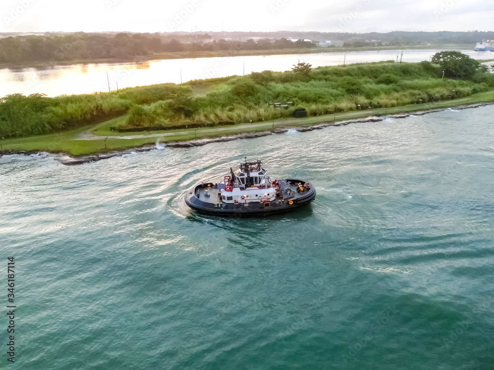 Fototapeta premium The patrol Panamanian tug boat guiding ships