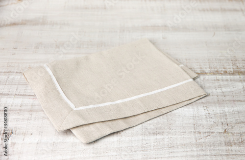 
Beige dough cotton napkin on a wooden table photo