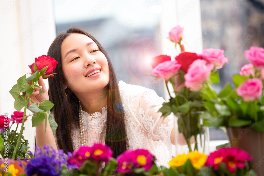 Woman Preparing to trim red and pink roses and beautiful flower arrangements in the home, flower arrangements with vase for gift-giving for Valentine's Day and Business in family on the on table Woman Preparing to trim red and pink roses and beautiful flower arrangements in the home, flower arrangements with vase for gift-giving for Valentine's Day and Business in family on the on table